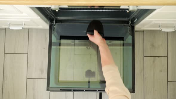 The Housewife Takes a Baked Chicken Out of the Oven alt