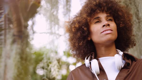 Young Woman Smiling In Botanical Gardens alt