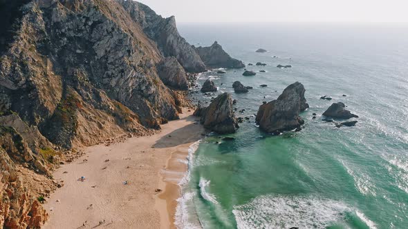 Aerial Drone Footage of the Beautiful Praia Da Ursa Beach in Sintra Portugal in Sunset Golden Hour