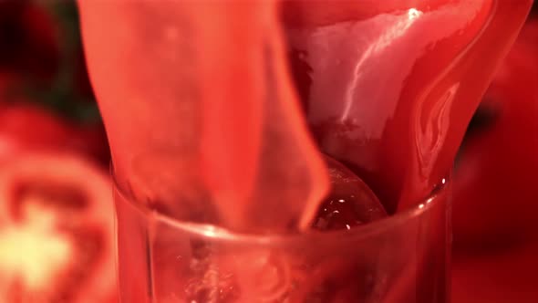 Super Slow Motion in a Glass with Tomato Juice Drops a Piece of Tomato alt
