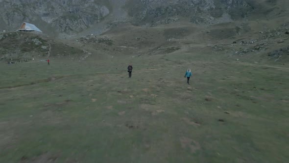 Aerial View Backward Movement Shot Over a Camping Site with Few Tents Beside the Pristine Lake Ayous alt