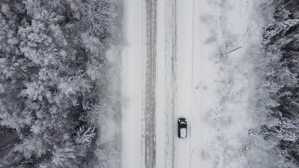 Aerial Top View From Drone Birds Eye View of Winter Landscape and Snowy Ice Road Car Moving on Area