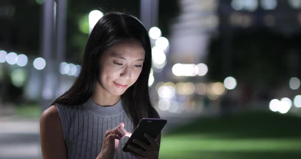 Woman use of mobile phone at outdoor alt