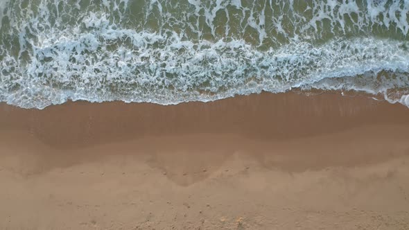 Top view of empty sandy beach and picturesque sea waves alt