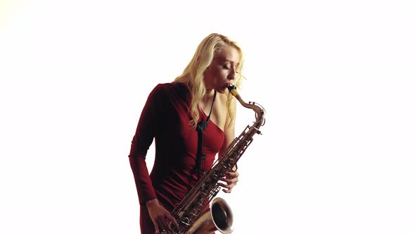 Woman Playing a Melody on Saxophone
