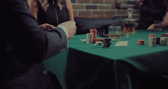 Man Deals Cards to Players alt