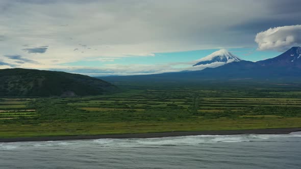 Beach with Black Sand and Volcano alt