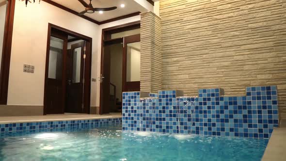Water Flowing Over Jacuzzi Into Indoor Swimming Pool. Slow Motion alt