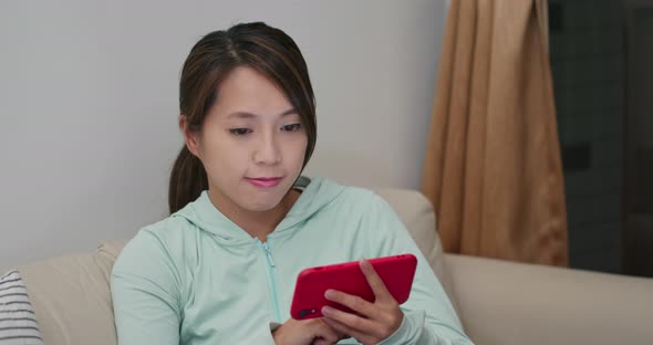 Woman use mobile phone at home alt