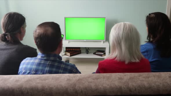 Family Watching TV. Green Screen. alt