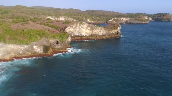 Aerial view of cliff formation on the coast of Bali island, Indonesia. alt