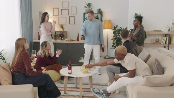 Young People Playing Guessing Game in Apartment alt