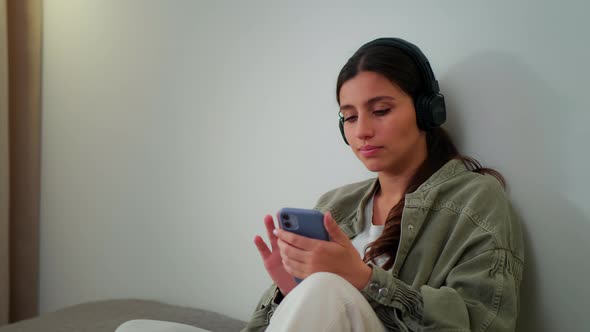 The Girl Listens to Music and Sits on the Phone