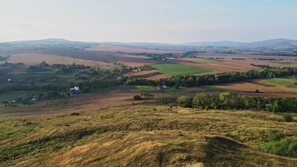 Flight over the hills behind the Ukrainian village Aerial view.