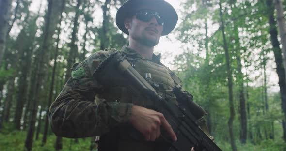 Portrait of Soldier with Riffle in Dense Forest