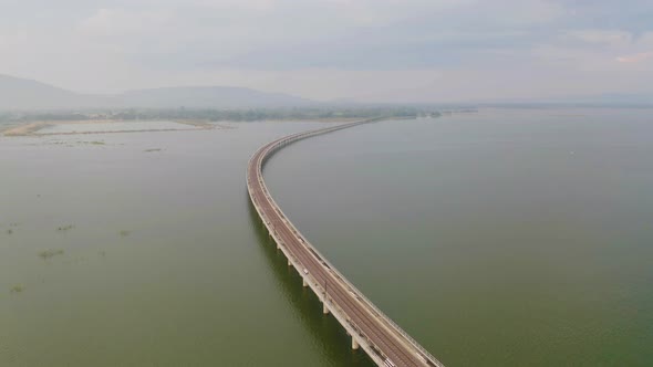 Aerial view of Thai local train on railway bridge at Pa Sak Jolasid Dam, the biggest reservoir alt