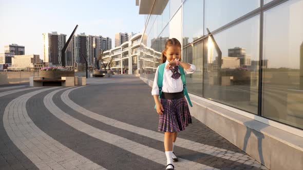 Child Girl in Uniform Is Going To School and Talking on Her Wrist Smart Watches