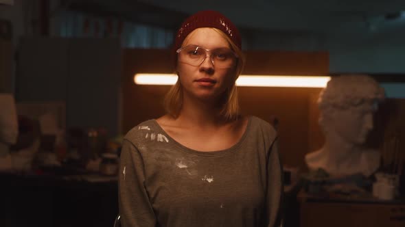 Female Sculptor in Dim Studio alt