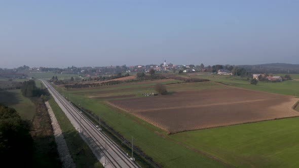 Aerial view of train tracks and farmland on the outskirts of the ...