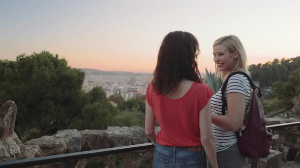 Young adult women taking picture on mobile phone in Barcelona