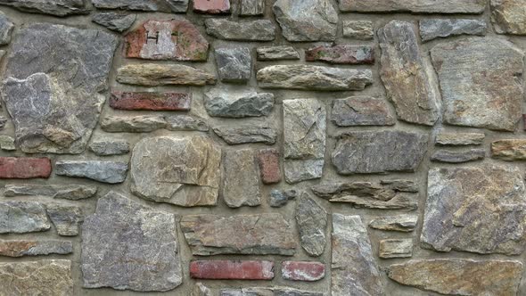 Masonry wall of multicolored stones or blocks