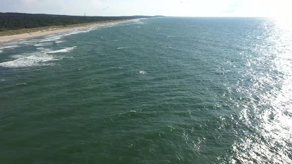 AERIAL: Flying Towards Surfers Riding with Wind Kites on Baltic Sea Waves