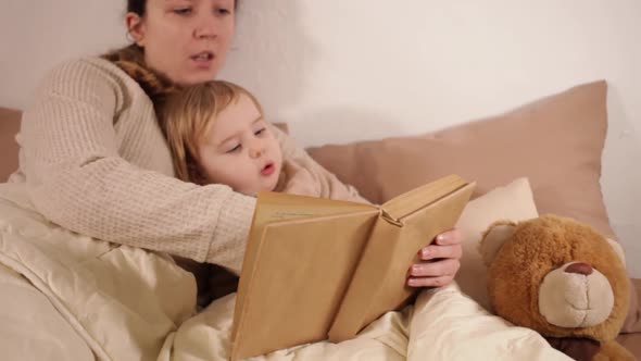 A Mother Reads Her Daughter a Bedtime Story
