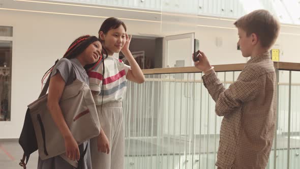 Diverse School Girls Posing for Smartphone Camera at School alt