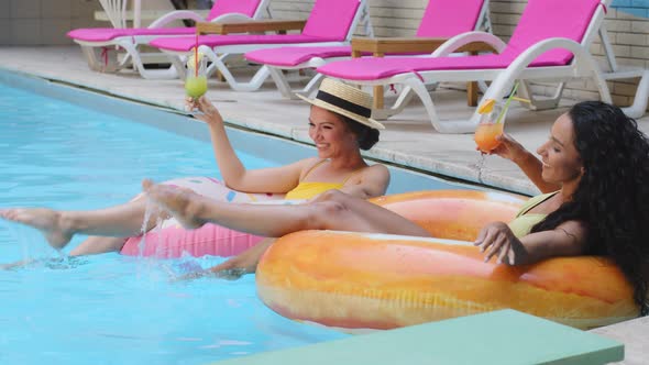 Beautiful Slender Girlfriends Have Fun in Summer Pool with Cold Refreshing Fruit Cocktails alt