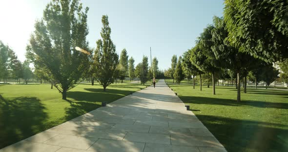 Young Sportswoman Runs in a Modern Park