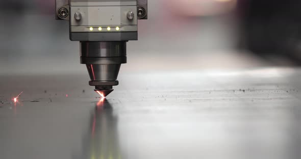 Laser Cutting Process On A Sheet Of Stainless Steel In A Factory
