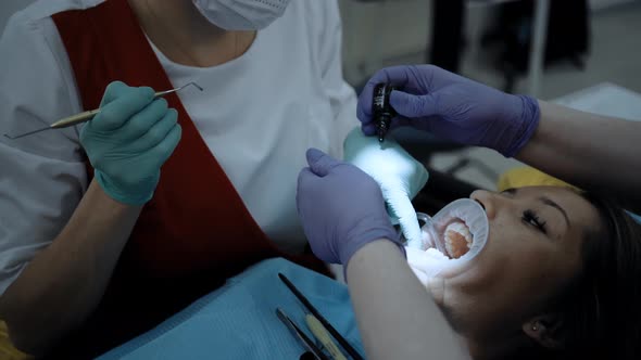 A Dentist at Work with Patient alt