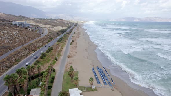 Flying over the mountain highway road and sea coastline at summer day in Crete. alt