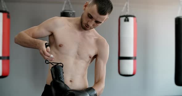 Fighter Puts on the Gloves in Slow Motion Boxer in the Gym Gets Ready to Train  Prores HQ 60 Fps alt