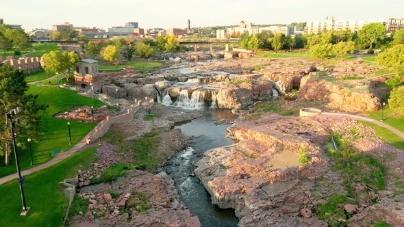 Overhead view of Falls Park with water flowing over rock features. Several observation points.