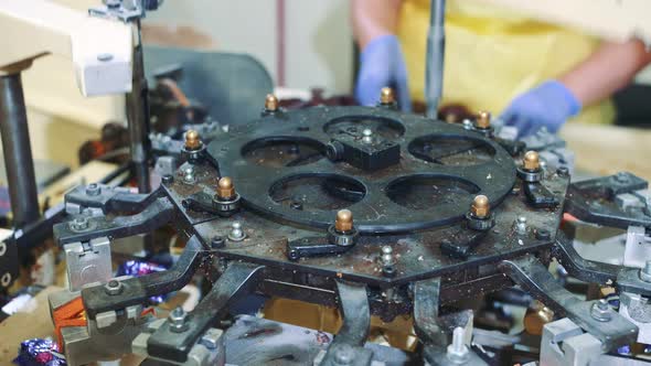 Modern Industrial Machine Wrapping Tasty Sweets and Putting Them on Conveyor on Confectionery alt