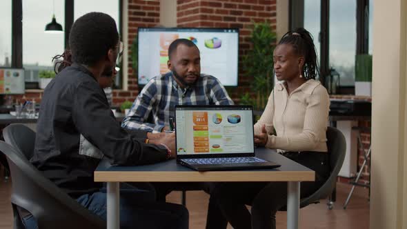 African American Team of People Using Financial Charts to Work alt