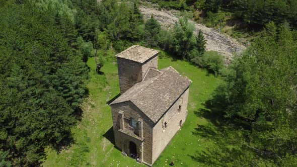 Aerial circular drone view of a mountain church alt