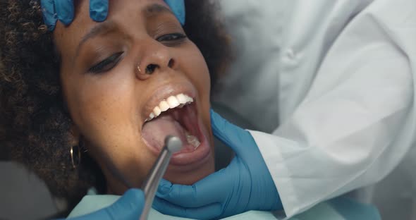 Close Up of Dentist with Assistant and Scared Female Patient During Checkup at Clinic alt