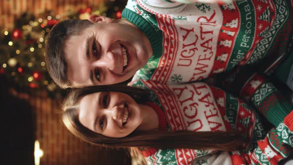 Vertical Portrait of Happy Smiling Married Couple in Festive Mood Video Chatting on Intrnet at Home