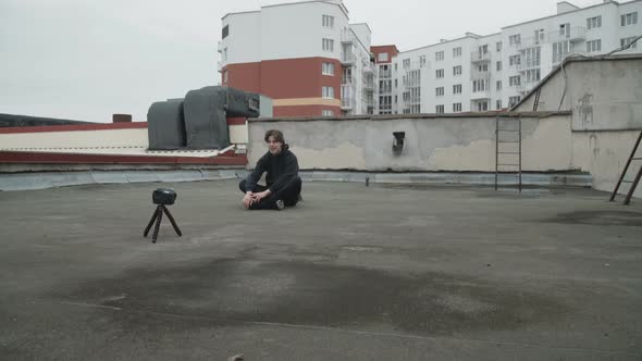 Handsome Reporter Shooting a Video By Himself on the Street Roof alt