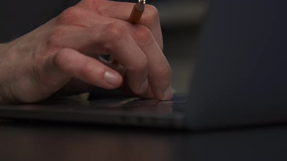 A Graphic Designer Draws a Prototype of an Icon Visual with a Pencil on Paper alt
