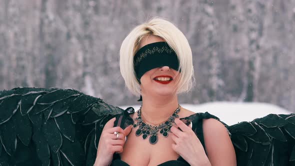 Lady with Black Wings Plays Phoenix Bird in Winter Forest alt