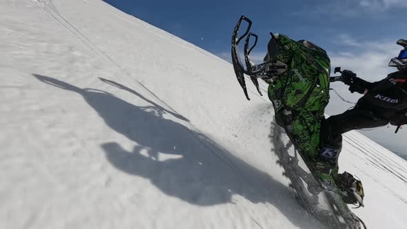 FPV Drone Aerial View Sportsman Riding Snowbike Stuntrading Rear Truck Willie Stop Pix Slow Motion alt