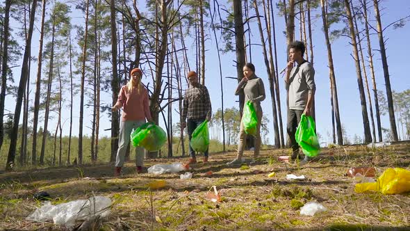 Volunteers Standing in The Forest and Get Ready to Clean It from The Trash and Plastic