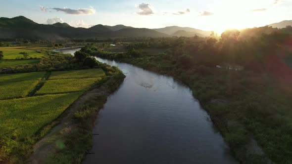 Aerial view of paddy field or rice terrace and the river in northern of Thailand by drone