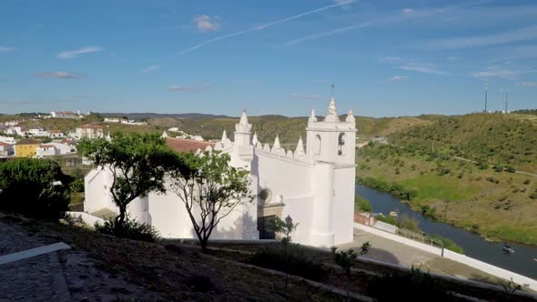 Slow and Slight Pan Out Shot of Church in Mertola and the Guadiana River Behind It in Portugal