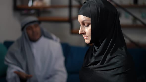Side View Portrait of Stressed Upset Middle Eastern Woman in Black Hijab Looking Away Thinking As alt
