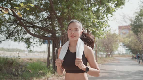 Young Asian woman running for outdoor exercise in the morning