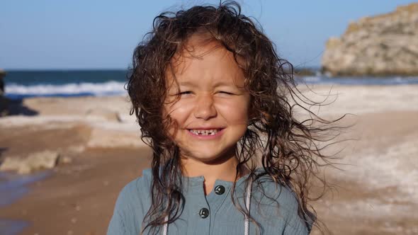 Portrait of a Happy Child Girl at the Beach.